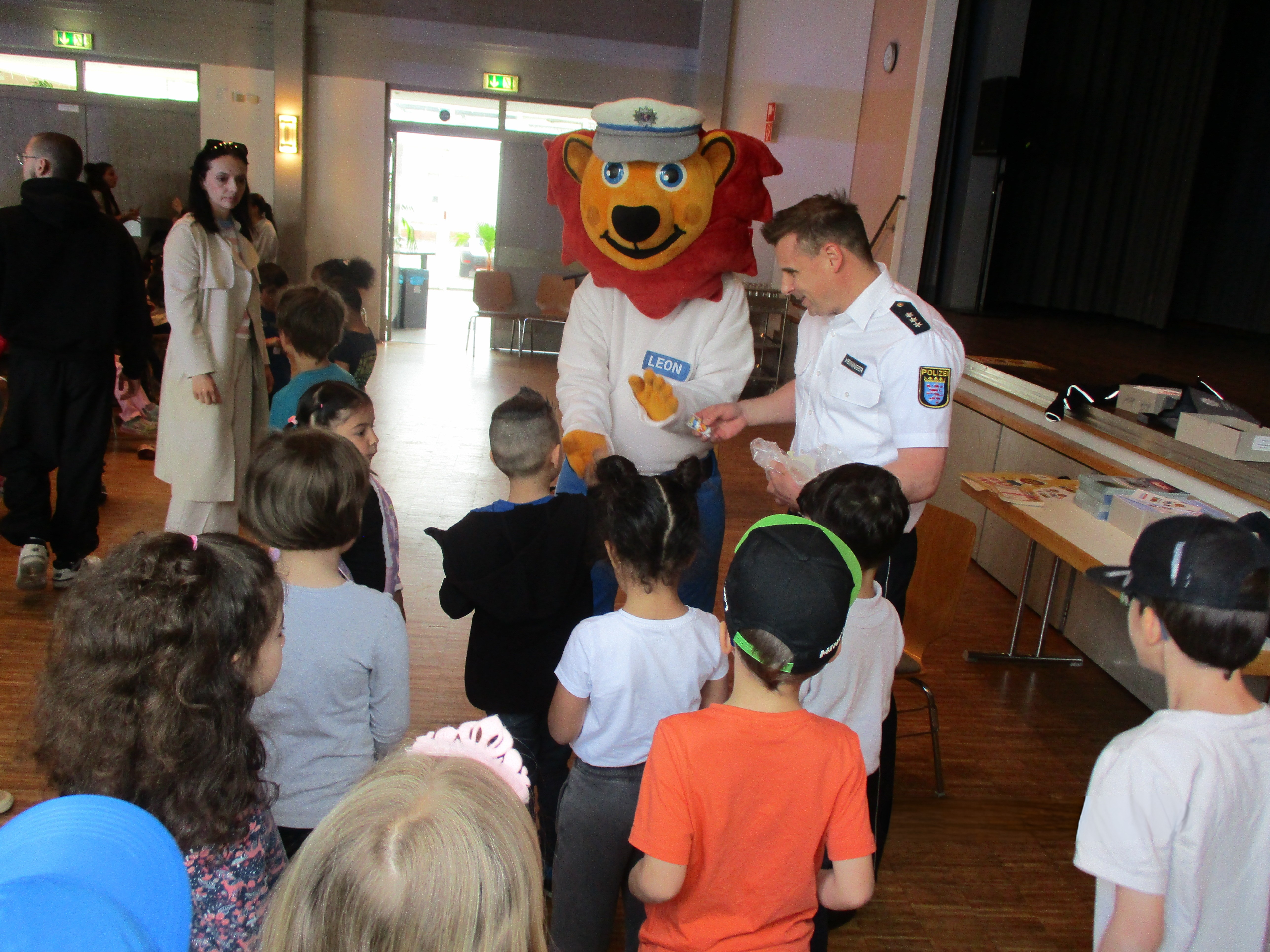 Löwe Leon mit Polizmten und Kindern